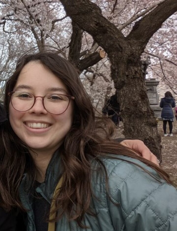 Photo of Becca wearing a green jacket.